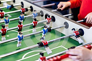 Blurred table football with shiny chrome figures close up
