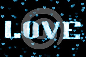 Blurred text blue LOVE sign LED Bokeh neon light blue on background bokeh lights heart soft colorful