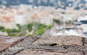 Blurred town view over a brick wall edge