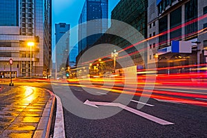 Blurred traffic light trails on road at night