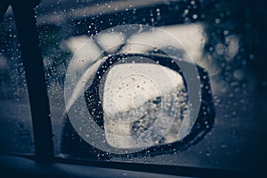 Blurred traffic on rainy day,Car window with rain drops on glass or the windshield