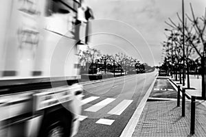 Blurred truck in the foreground with a road in front