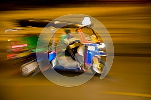 Blurred tuk-tuk taxi in Bangkok, Thailand