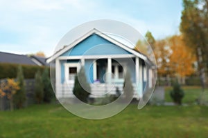 Blurred view of beautiful light blue house outdoors. Real estate