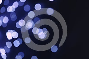 Blurred view of beautiful lights on dark background, space for text