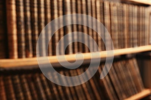 Blurred view of books on shelves in library