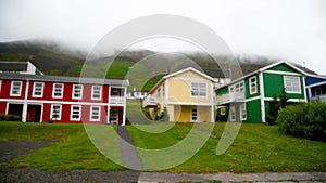 Blurred view of colorful homes in the countryside on a cloudy day. Slow motion