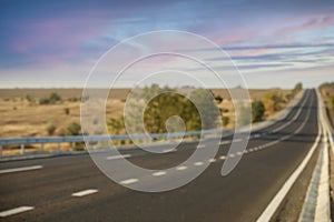 Blurred view of empty asphalt highway. Road trip