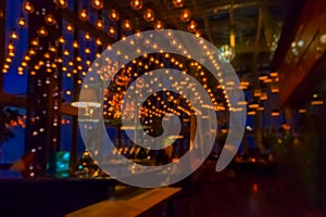 Blurred view of the interior of the bar in the evening for pattern and background