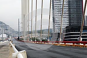 Blurred view of modern bridge near city photo