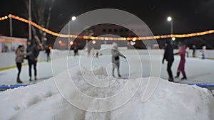 Blurred view of an outdoor ice rink in the city.