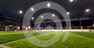 blurred view of soccer or football stadium with players and bright lights used for sport background.