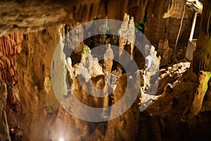 Blurred warm abstract background of stalactites, stalagmites and stalagnates in Sfendoni cave, underground, horizontal