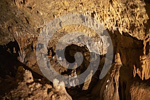 Blurred warm abstract background of stalactites, stalagmites and stalagnates in Sfendoni cave, underground, horizontal