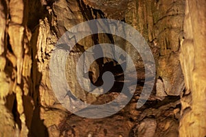 Blurred warm abstract background of stalactites, stalagmites and stalagnates in Sfendoni cave, underground, horizontal