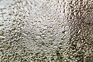 Blurred water droplets on the windscreen..