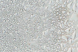 Blurred water droplets on the windscreen..