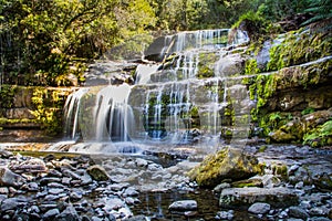 Blurred water over Liffey Falls, Tasmania in the afternoon light.