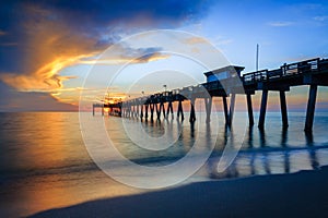 Blurred water softens as the sun sets over Venice Pier in Florida photo