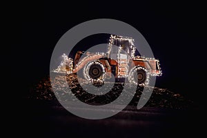 Blurred wheel loader decorated with lights