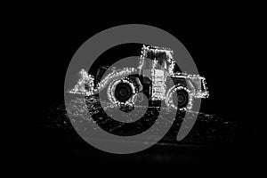 Blurred wheel loader decorated with lights