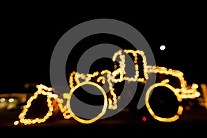 Blurred wheel loader decorated with lights/bokeh lights on a wheel loader