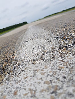 Blurred white markings on the asphalt road