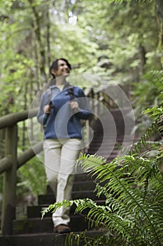 Blurred Woman Walking Down Forest Stairs