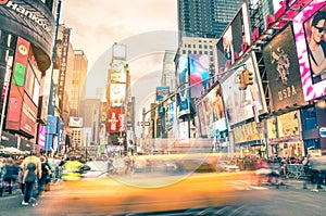 Blurred yellow taxi cab and rush hour in Times Square New York