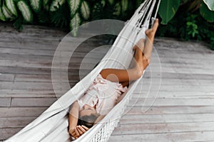 Blurred Young beautiful woman relaxing in hammock