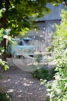 Blurredbackground with trees, vintage camper van and light garland