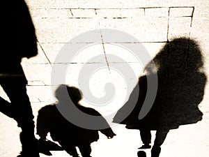 Blurrry shadow silhouete of  people walking in high contrast  black and white