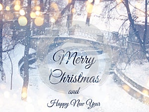 Blurry and abstract magical winter landscape photo with greeting text: Merry Christmas and happy new year