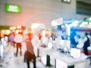 Blurry background of exhibition expo with crowd people in convention hall. Abstract concept. Business marketing and event theme.