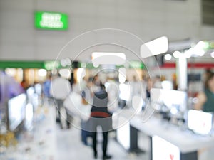 Blurry background of exhibition expo with crowd people in convention hall. Abstract concept. Business marketing and event theme.