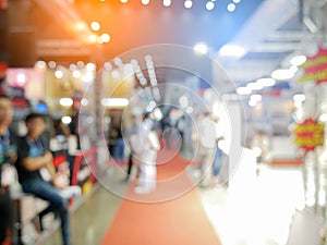 Blurry background of exhibition expo with crowd people in convention hall. Abstract concept. Business marketing and event theme.