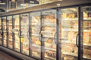 Blurry background frozen pizza in freezer at American supermarket