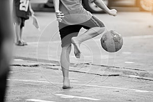Blurry ball after futsal players shoot it. Futsal players barefoot