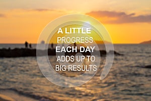 Blurry beach at sunset background with Inspirational quote - A little progress each day adds up to big results