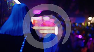 Blurry with bright background: People partying and clubbing at a nightclub