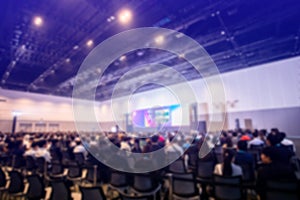 Blurry business man and woman sitting with chairman of the meeting and executive committee background in auditorium for