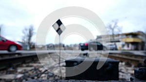 Blurry Cars and People at Railroad Crossing