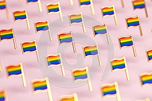 Blurry close-up focus on Rainbow LGBTQ flags pattern. June the gay pride month symbol concept.  on pastel pink background