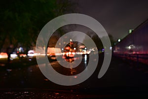 Blurry and contrast photo of lights on the street of a small town