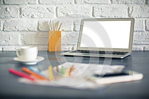 Blurry desk with white laptop