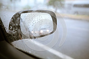 Blurry drop of rain on car side mirror on the road with vintage