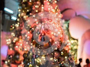 The blurry focus on the red christmas tree with the light decoration, makes it become star shape bokeh everywhere on it. Merry Ch