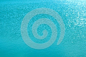 Blurry image of calm blue water texture. Abstract nature texture background. Cropped shot of an ocean.
