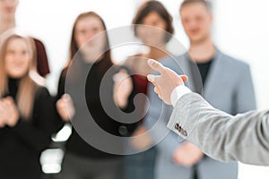 Blurry image of a group of different people standing in a conference room.