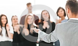 blurry image of a group of different people standing in a conference room.